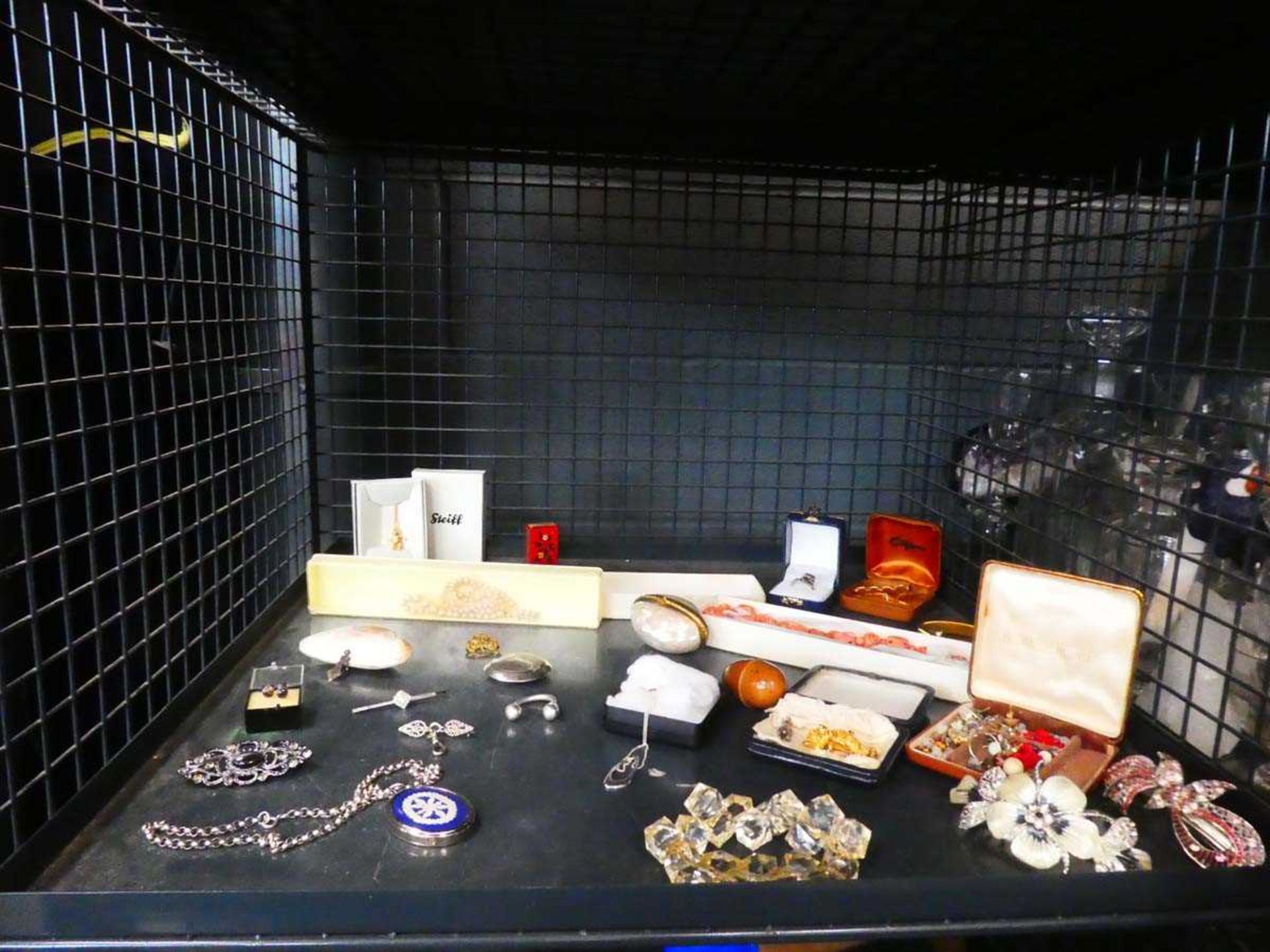 Cage containing quantity of costume jewellery