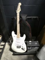 Fender Squire Stratocaster electric guitar with carry case and amplifier