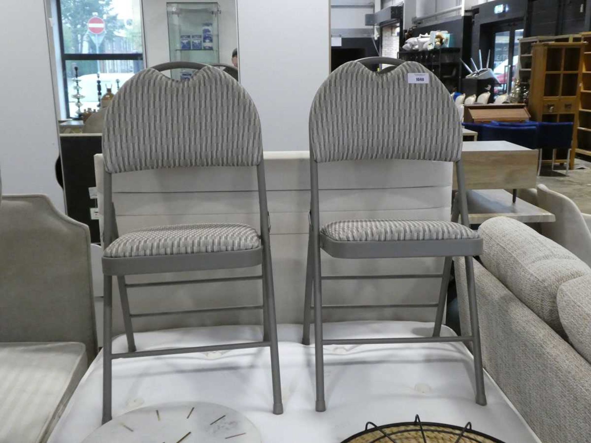 +VAT Pair of light grey metal soft seated folding chairs