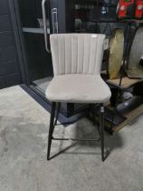 Beige suede upholstered bar stool on black metal support