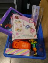 Blue crate containing various dolls and toys to include Frozen, mermaid, dinosaur toys, etc