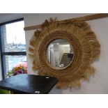 +VAT Circular wall mirror in woven natural fibre tussled frame Smaller mirror cracked