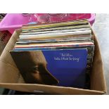 Box containing vinyl records to include Phil Collins, Eurythmics, John Lennon, etc