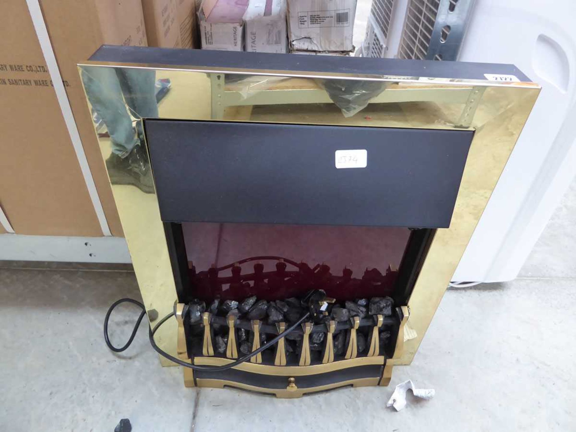 Black and brass coloured electric fire