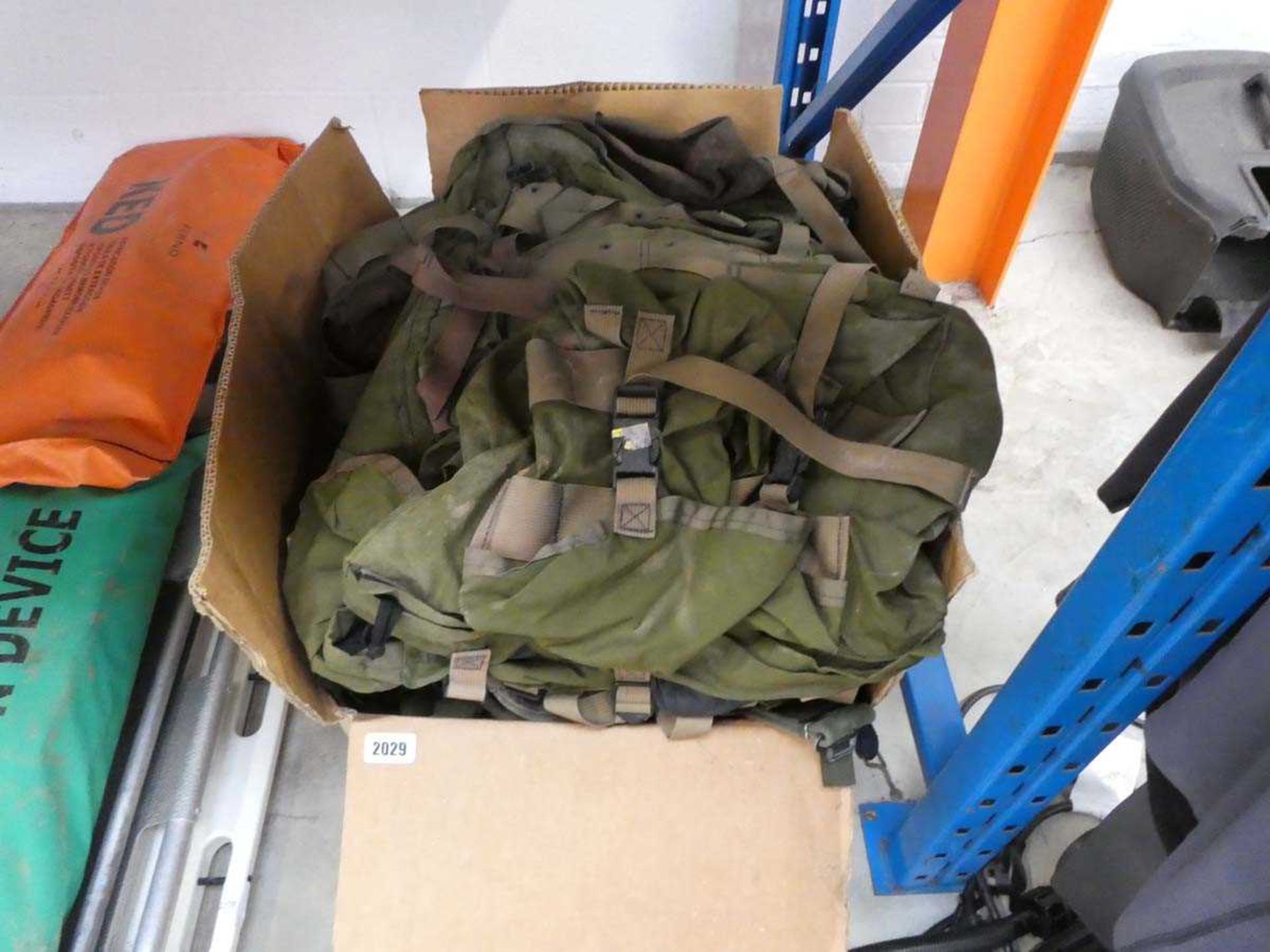 Box containing a large quantity of military style bags