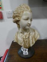 Bust of young boy on circular stand