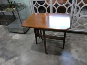 Small drop side mahogany table on castors