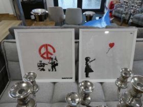 Modern pair of square white framed prints depicting Banksy artworks with 2 further prints after