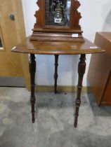 Shield shaped side table in walnut finish on 3 turned supports