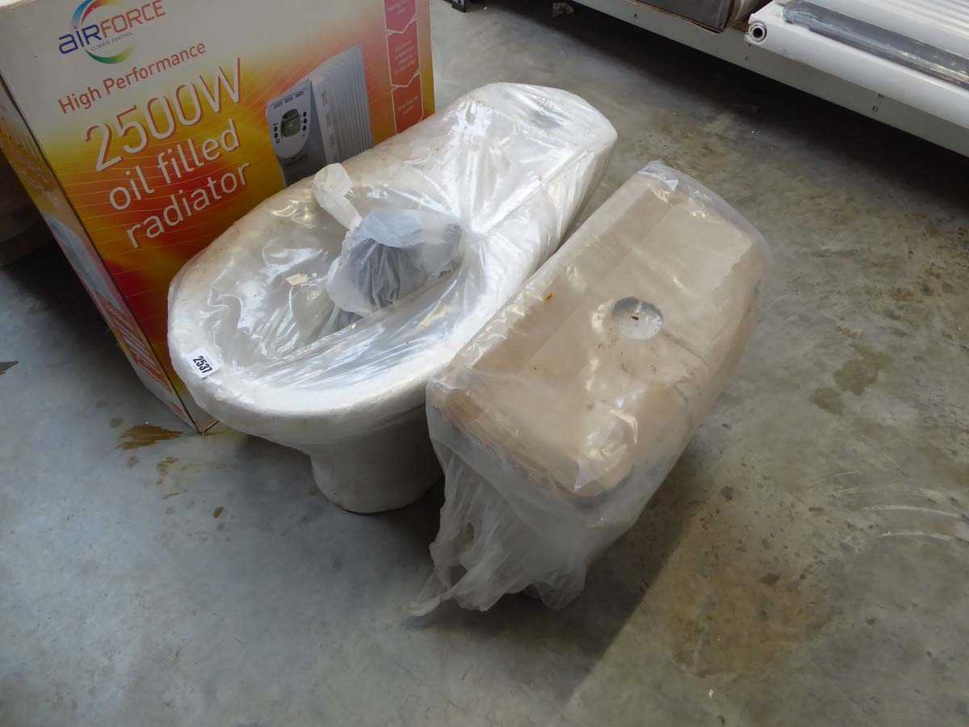 White ceramic toilet bowl and cistern