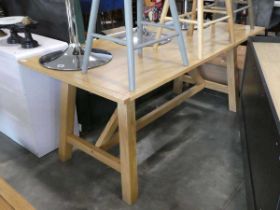 Modern light oak trestle type dining table