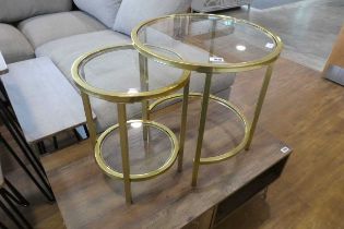 Nesting pair of brass finish circular glass top coffee tables