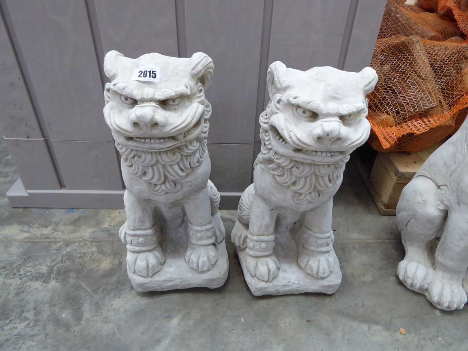 Pair of concrete kneeling Chinese lions