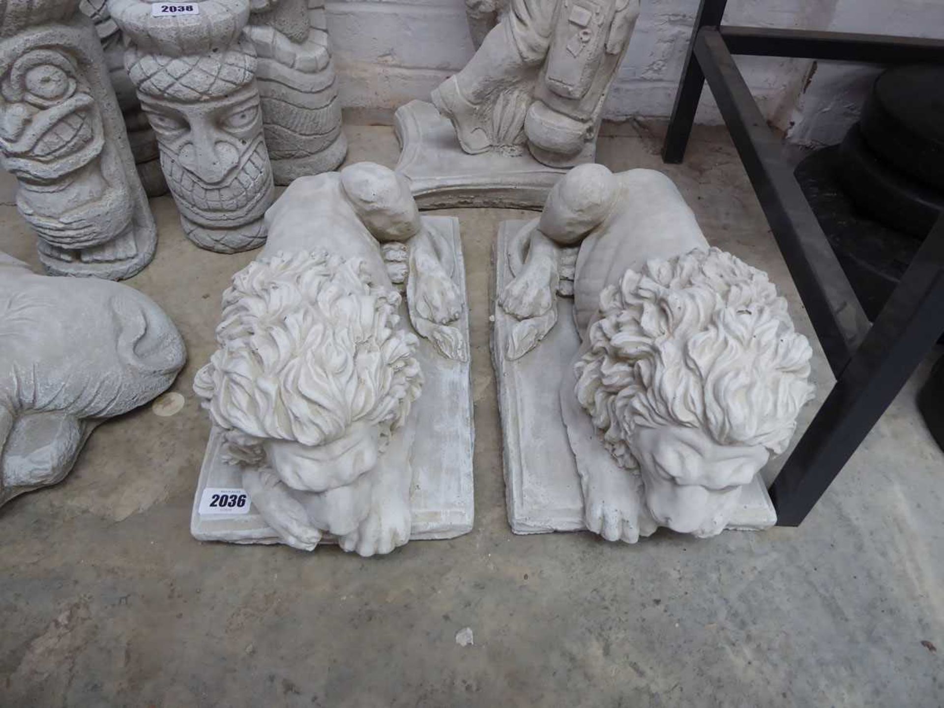 Pair of laying down concrete lions