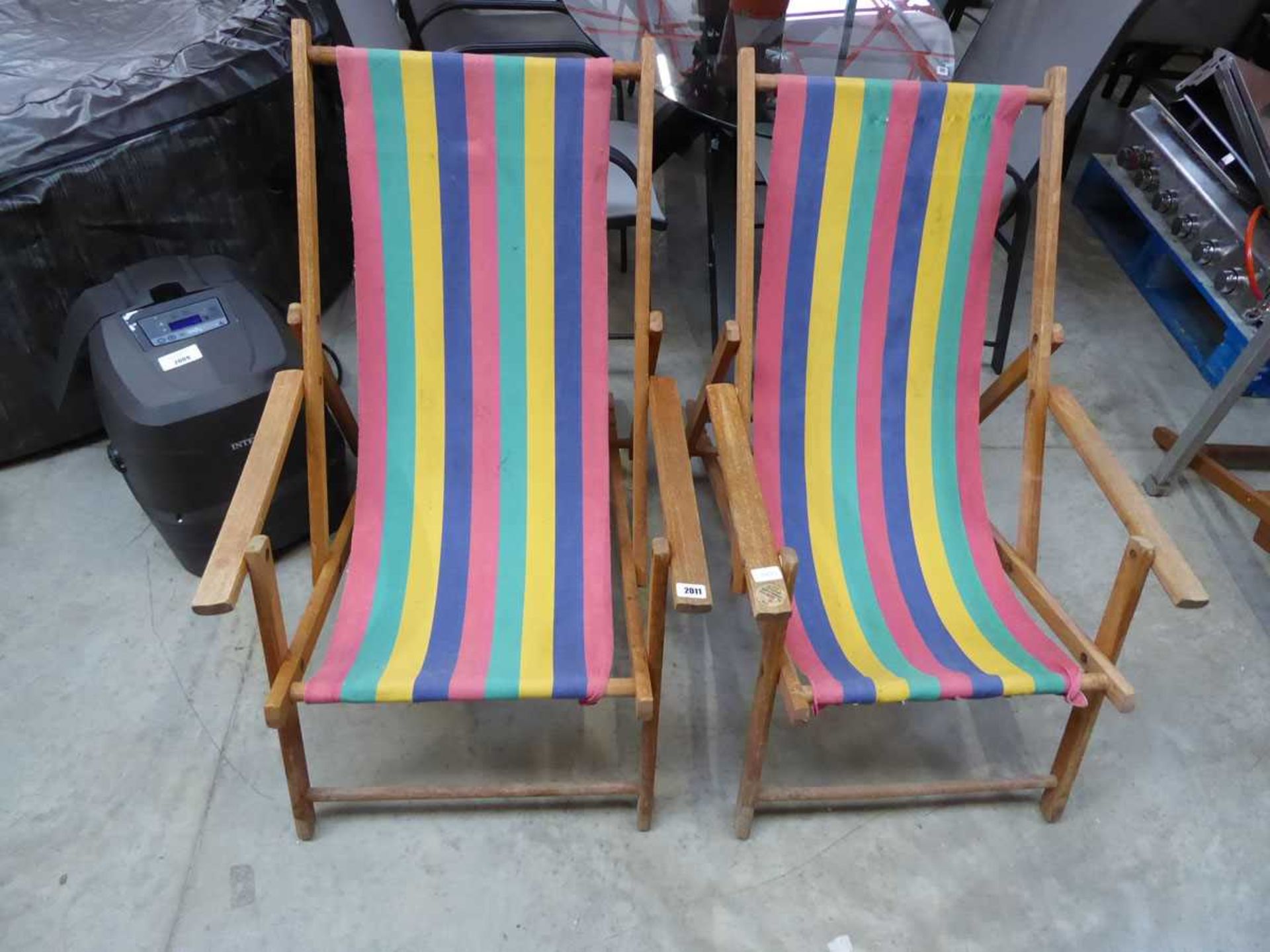 Pair of teak framed multicoloured upholstered sun loungers