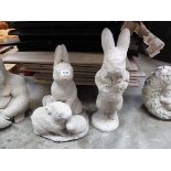 Concrete hare together with a trio of rabbits