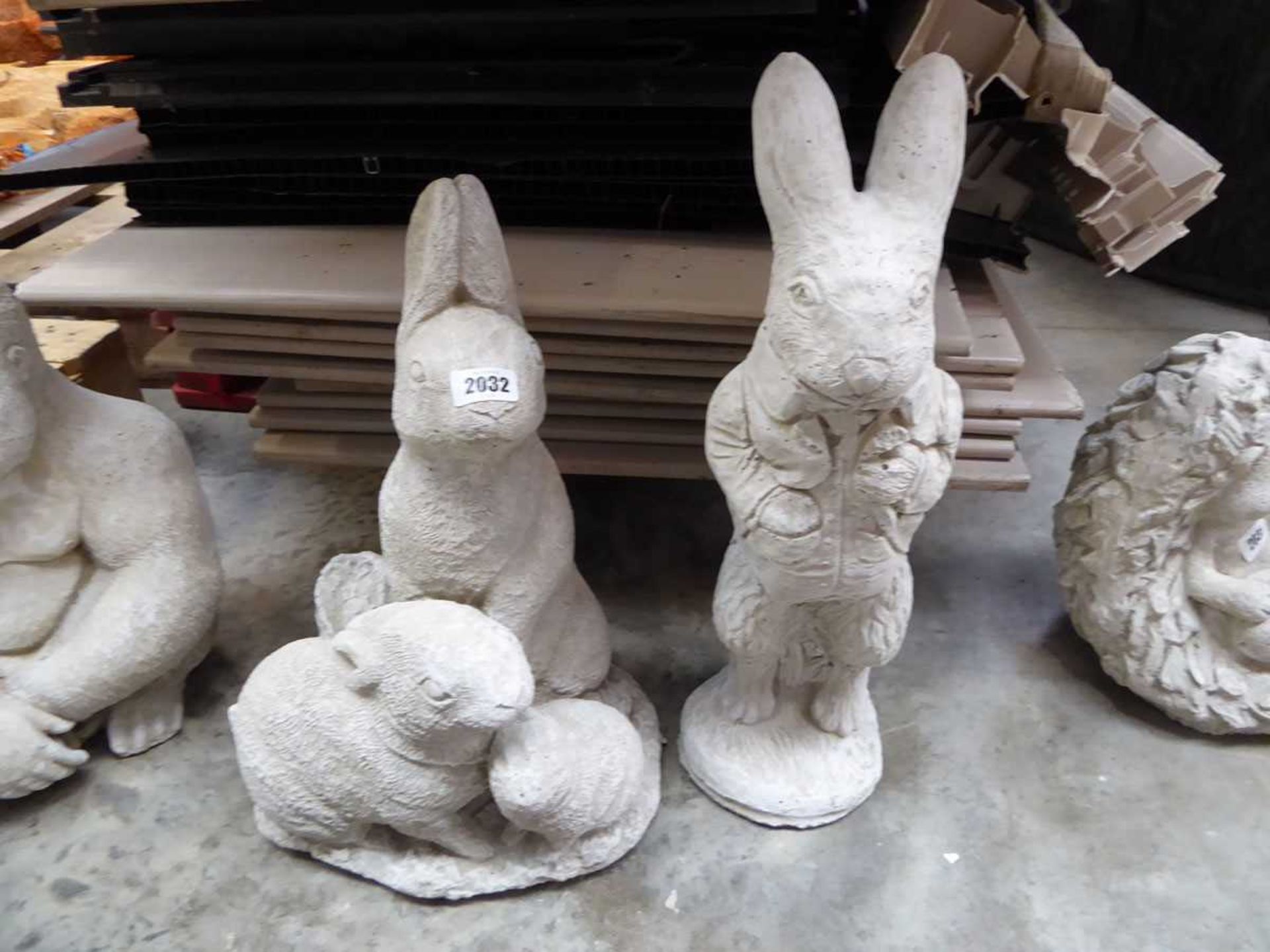 Concrete hare together with a trio of rabbits