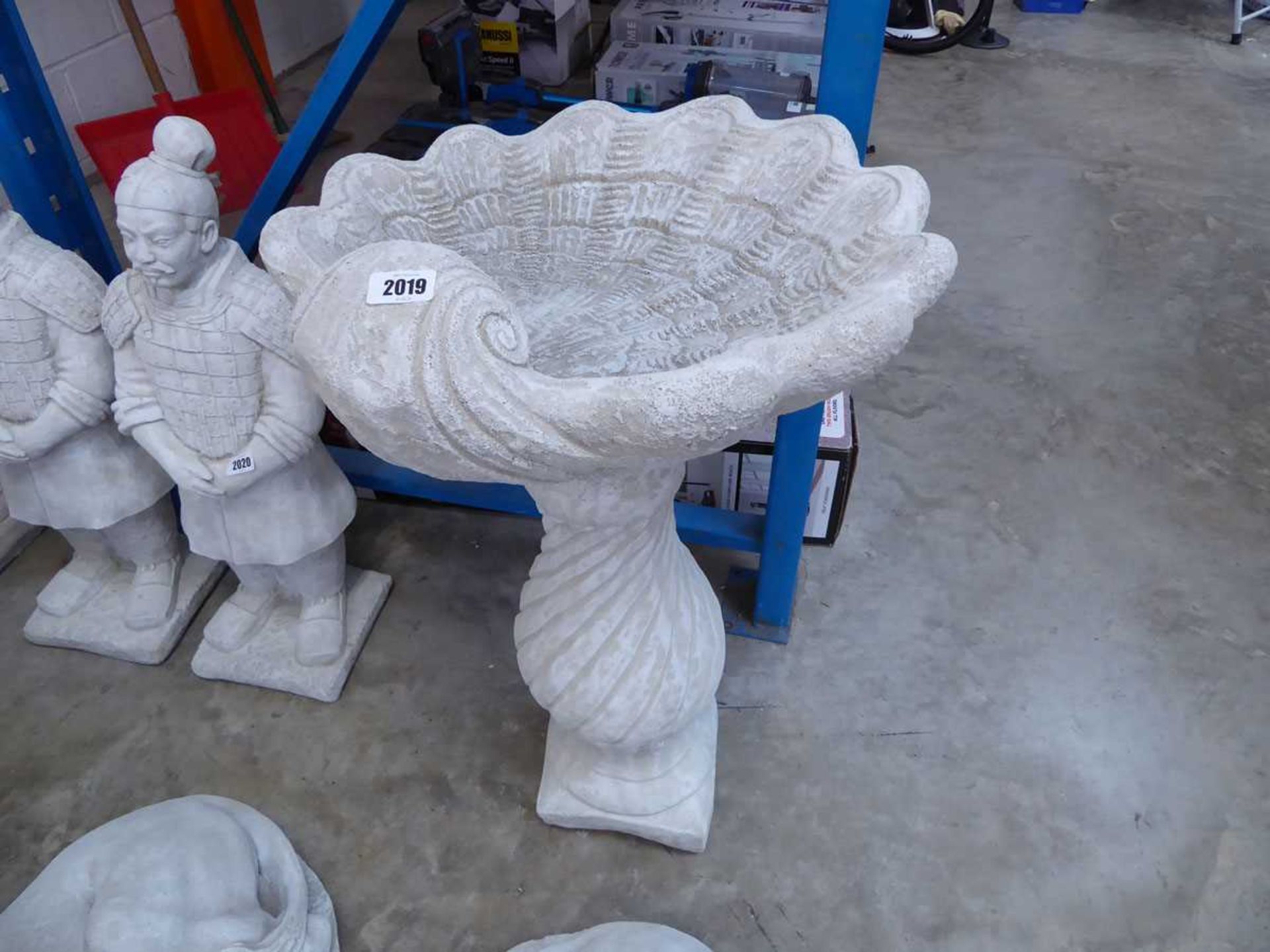 Large concrete shell shaped columned bird bath