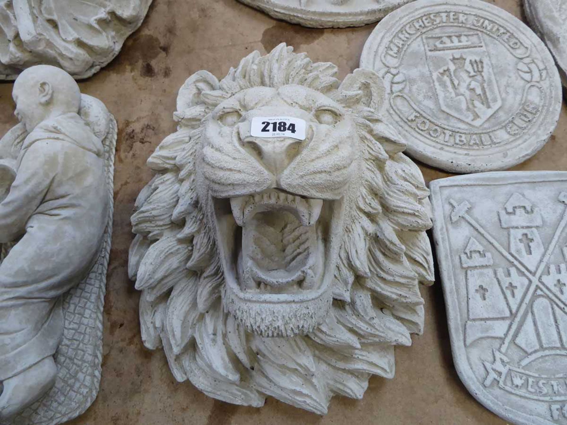 Large concrete lion face wall plaque