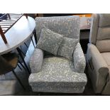 Light blue and beige floral upholstered easy chair on castors