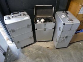 3 aluminium pull along trolleys, 2 empty and 1 containing a portable spray tanning machine