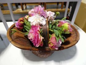 Bouquet of artificial flowers in wicker basket