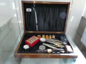Dark oak box containing a variety of pocket watches, watch repair tools, etc