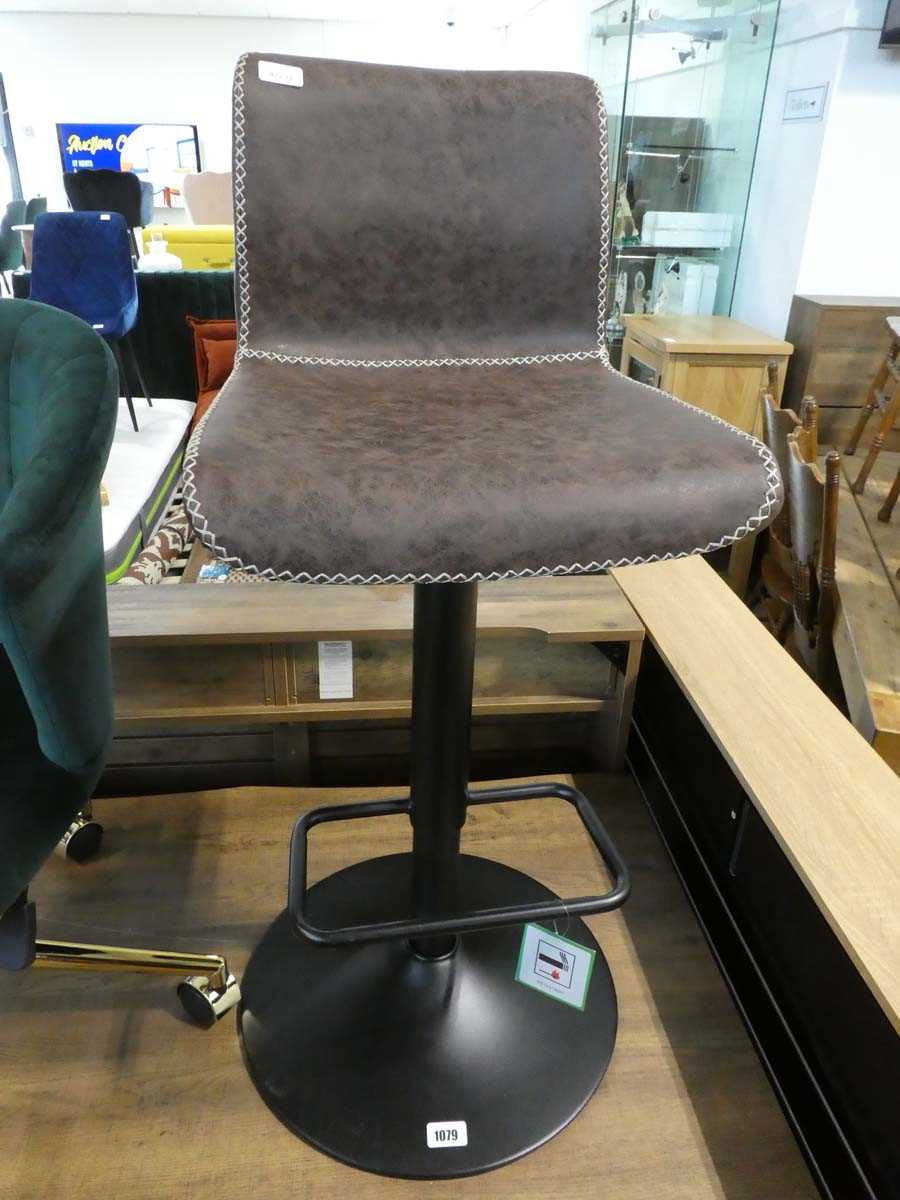 Brown leatherette upholstered bar stool on black metal support