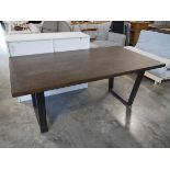 Dark hardwood finish dining table on black metal U-shaped supports