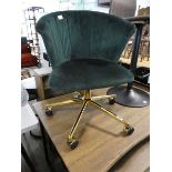 Shell shaped green upholstered revolving chair on brass 5 star base