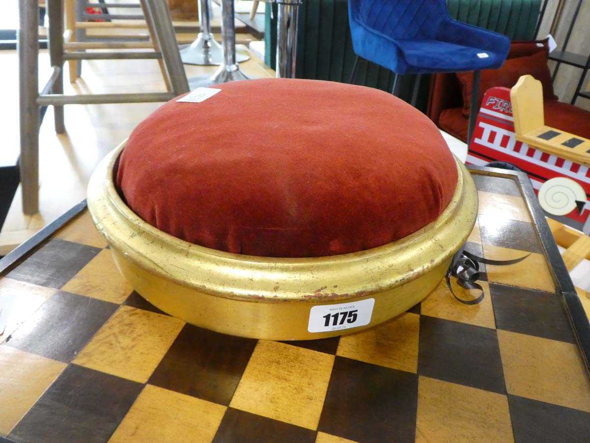 Small circular gilt footstool with red upholstered cushion