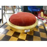 Small circular gilt footstool with red upholstered cushion