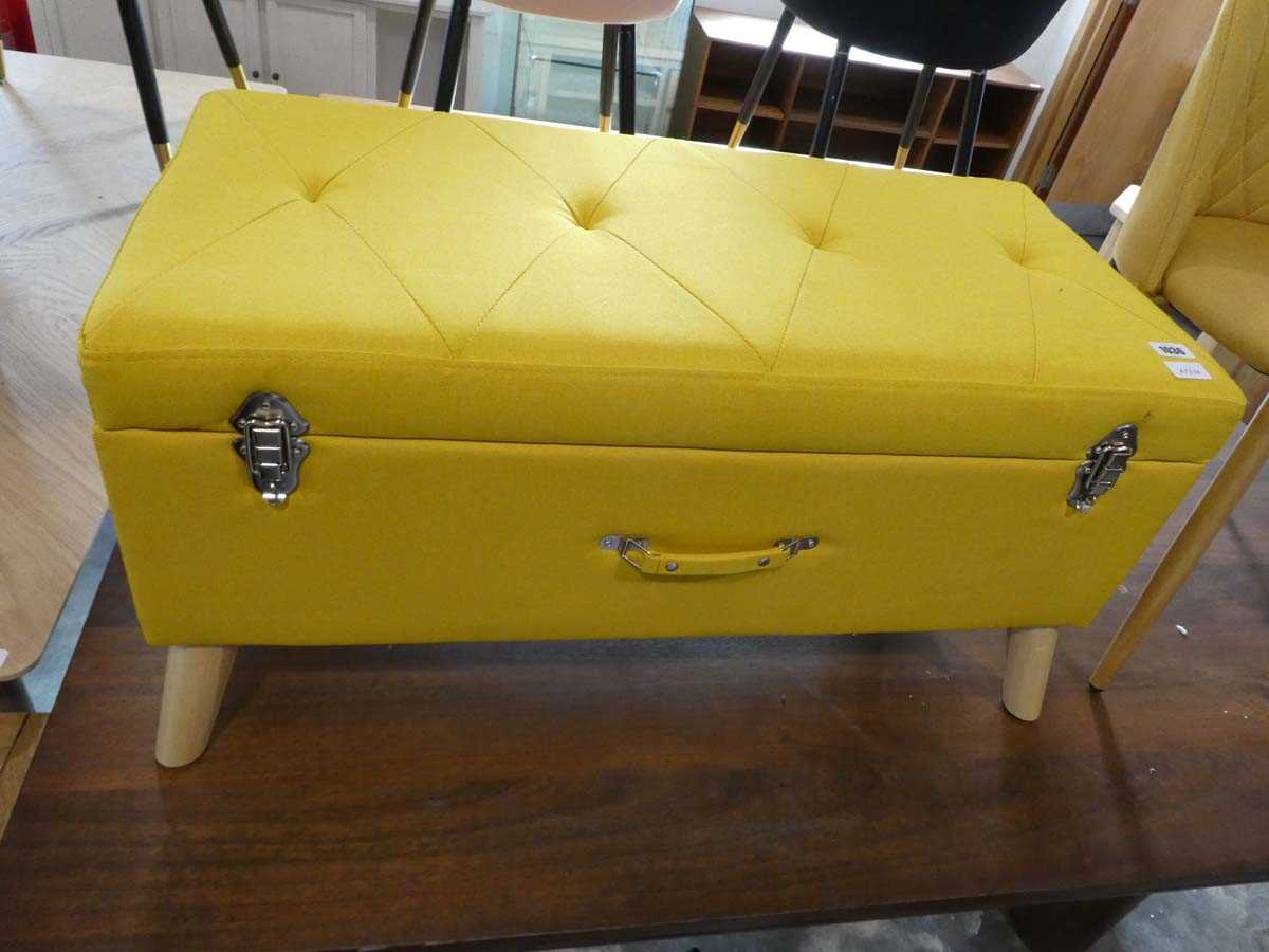 Modern yellow upholstered ottoman in the form of a case
