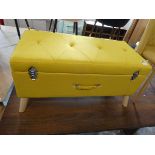 Modern yellow upholstered ottoman in the form of a case