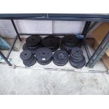 Large quantity of mixed size weights with weight lifting bar