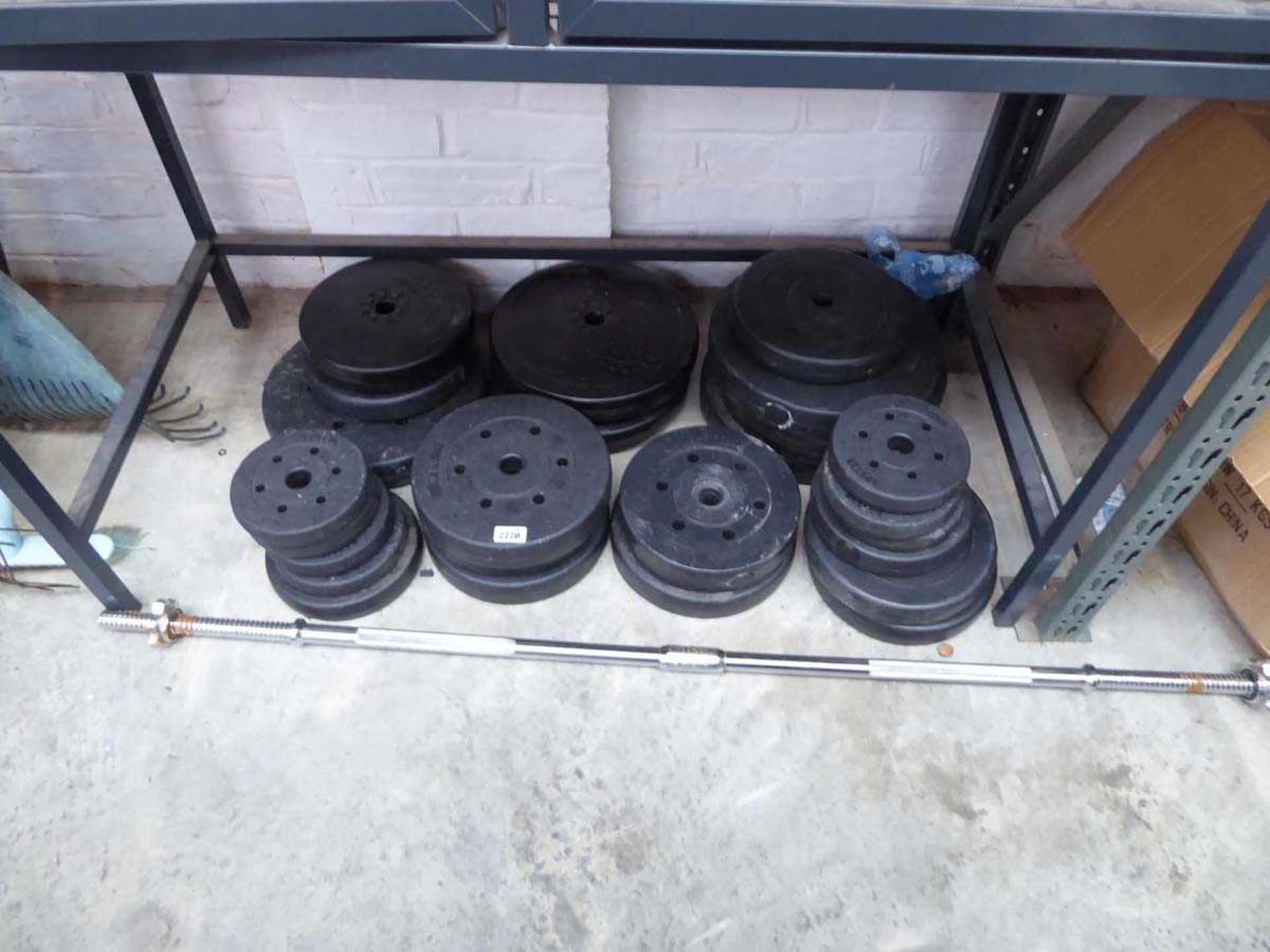 Large quantity of mixed size weights with weight lifting bar