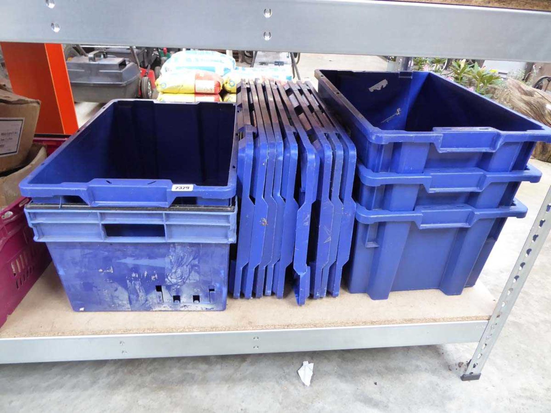 Large quantity of blue stacking crates with lids