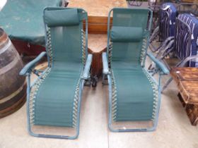 Pair of green reclining garden sunloungers