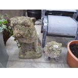 Pair of weathered concrete dogs
