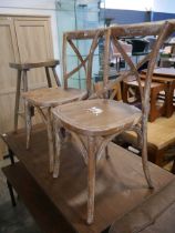 Pair of distressed style wooden dining chairs with wooden stool