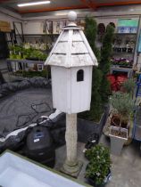 Wooden dove house on concrete pillar