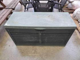 Green plastic outdoor storage bench