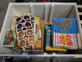 Bucket containing a boules set, various jigsaws and other games