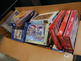 Large box of assorted jigsaw puzzles