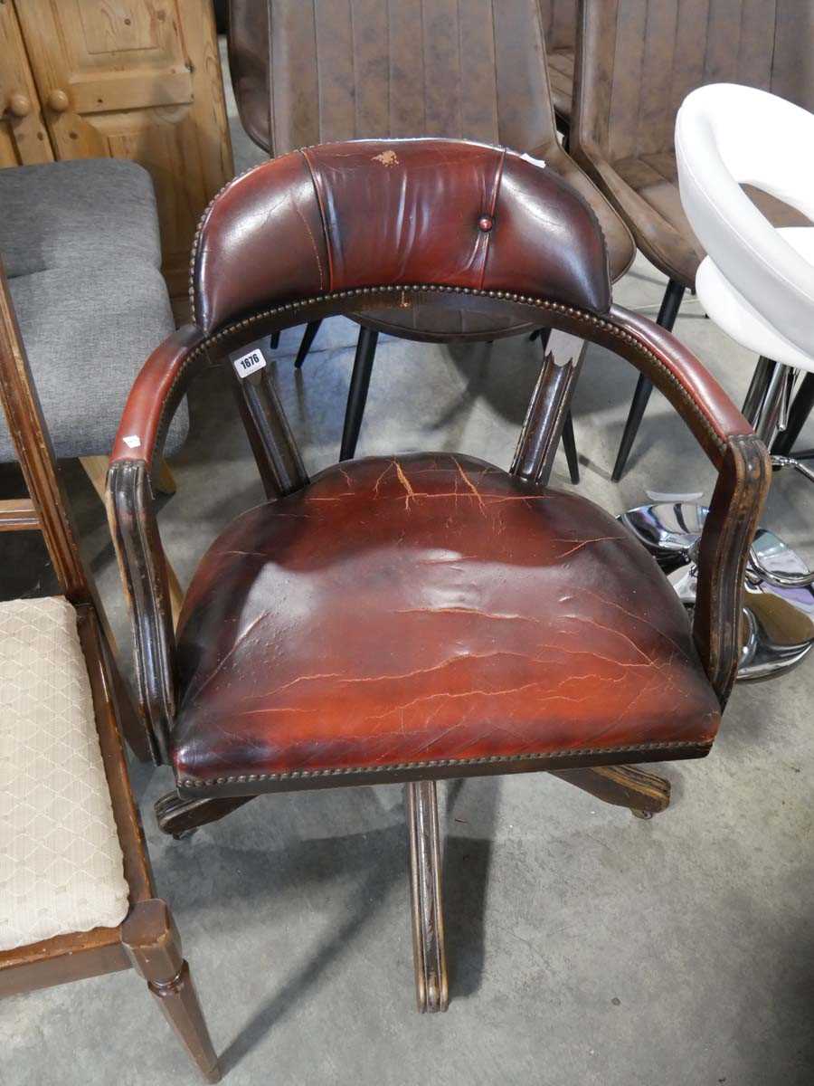 Red leather upholstered desk chair on wooden frame and 5 star support