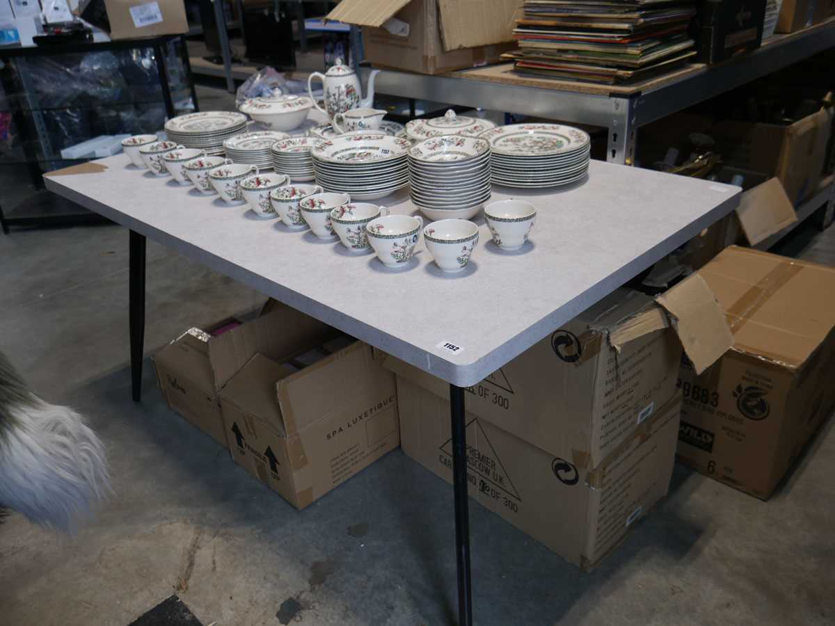 Modern grey dining table on black tapered supports and 5 diamond stitch concrete coloured suede