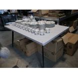 Modern grey dining table on black tapered supports and 5 diamond stitch concrete coloured suede