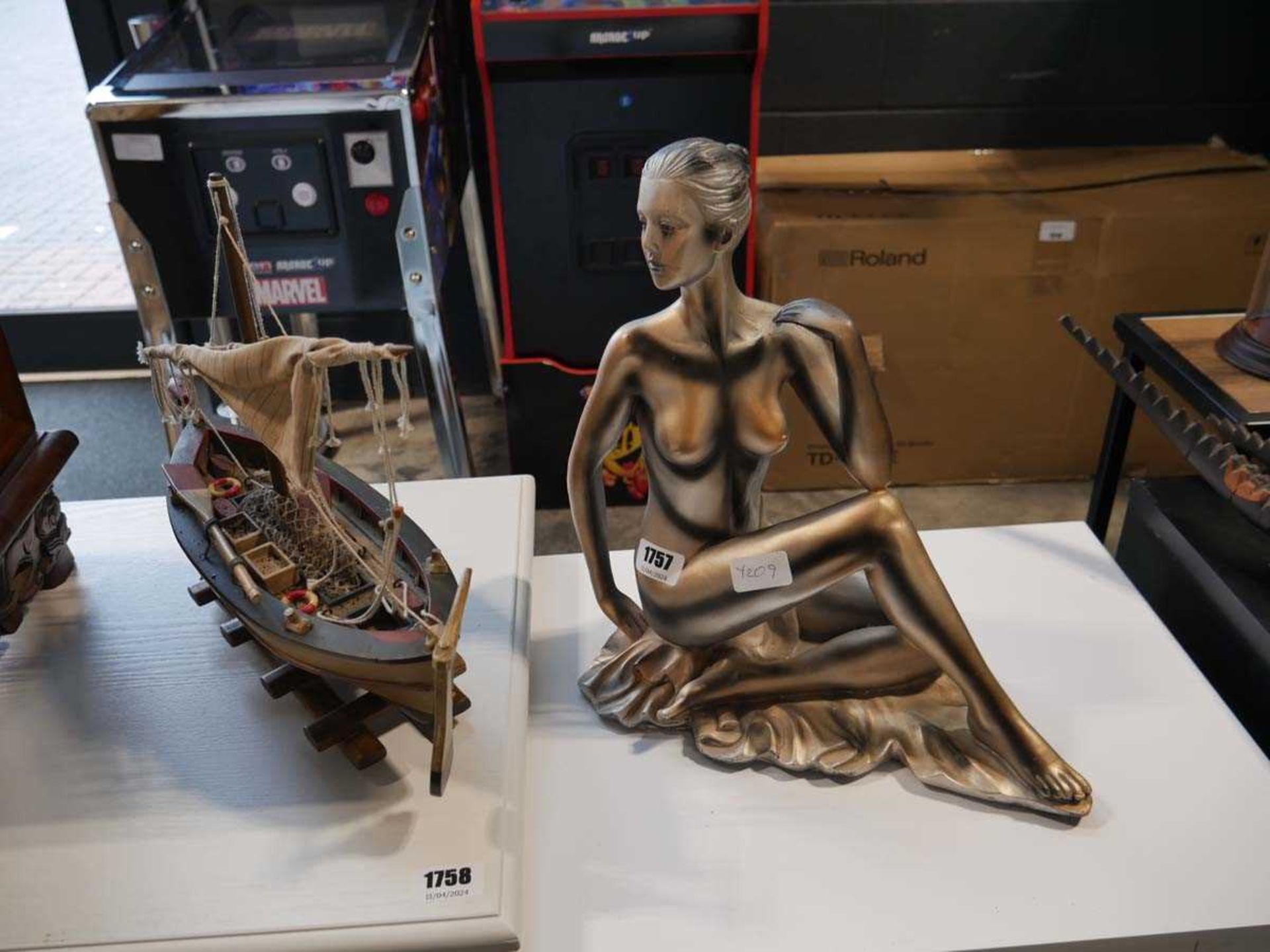 Model boat and ornament of a female nude