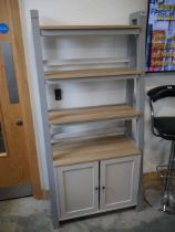 Modern grey and hardwood finish ladder shelf unit with cupboard to base
