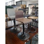 3 various stools; 1 in a brown leatherette finish, 1 in a grey upholstered finish and 1 in a black